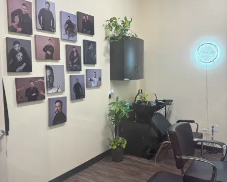 The wall of portraits and the wash basin at the back of the studio