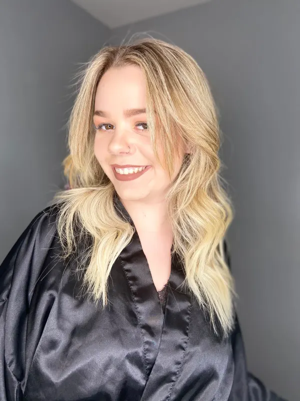 Golden blonde waves set soft, with the root left a shade deeper
