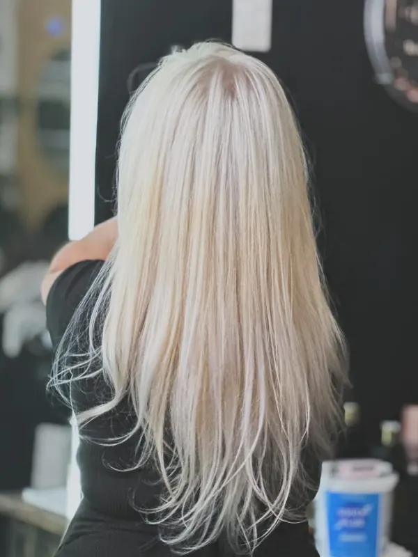 Icy platinum blonde carried from root to end, worn long and straight