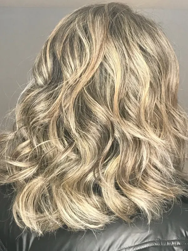 Lived in blonde on a lob, a soft shadow left at the root so the grow out never shows a line