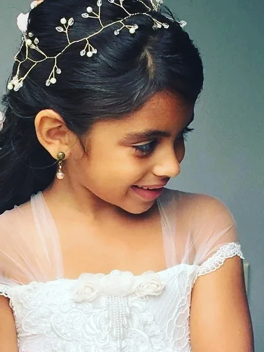 Flower girl half up dressed with a pearl vine and small roses
