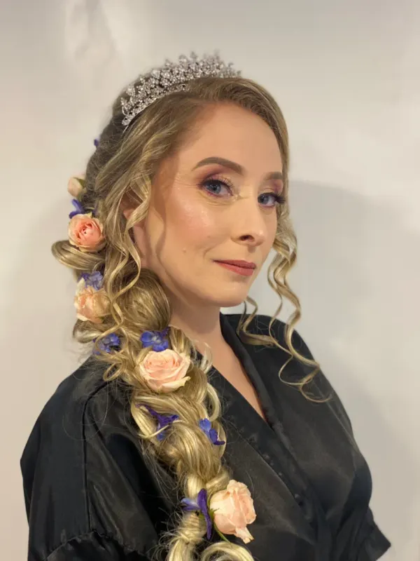 Side braid dressed out with fresh flowers, worn over one shoulder