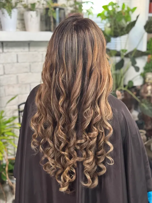 Bronde balayage on long hair, curled from the mid lengths down