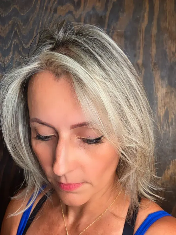 Full highlights in a cool ash blonde, woven through the whole head and kept soft at the root