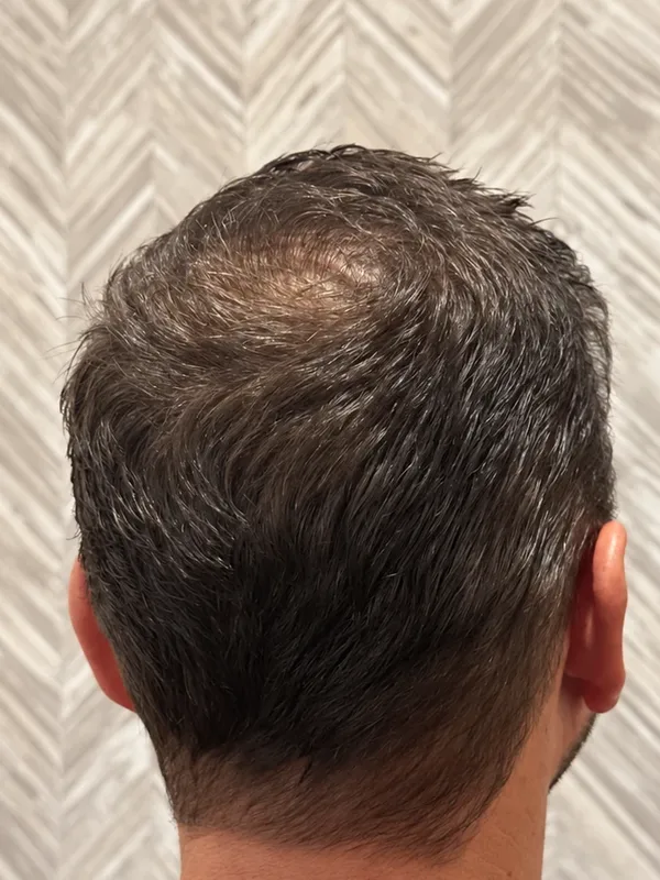 Mens cut tapered short through the back and sides, texture left on top