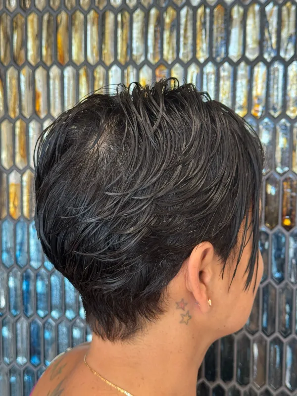 The same pixie from the side, the top cut long and left to fall forward