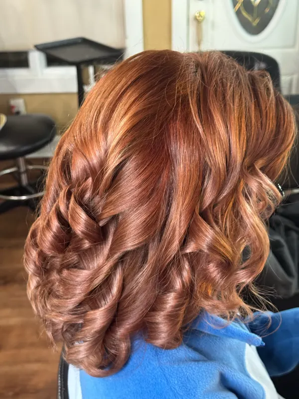 Copper curls set round and full, seen from the back