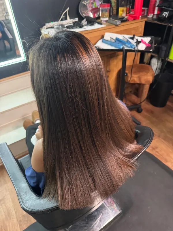 After the smoothing, from the side: the same hair straight, even and moving as one piece