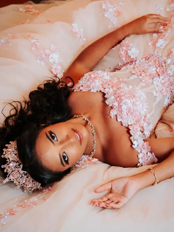 Quinceañera hair set in soft curls and pinned under a crown